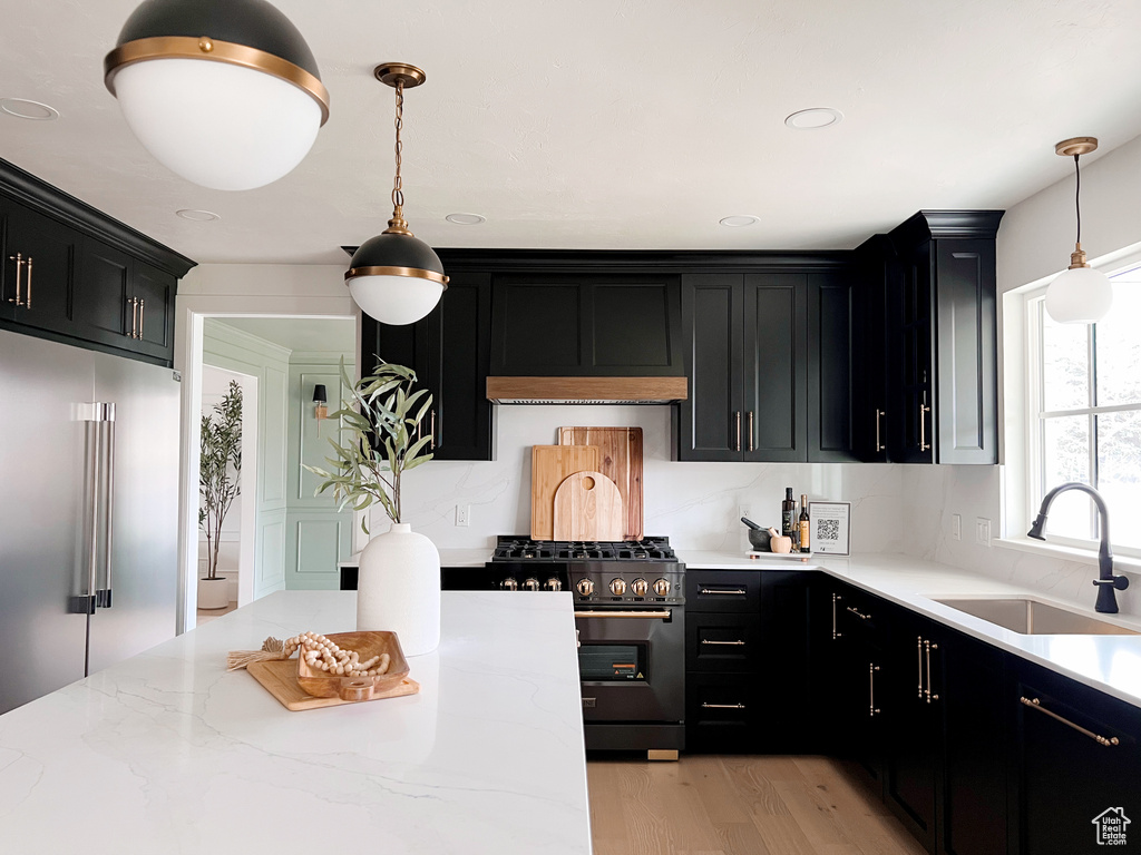Kitchen featuring stainless steel appliances, a sink, and dark cabinetry