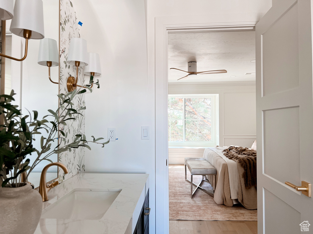 Bathroom featuring wood finished floors, vanity, and a ceiling fan