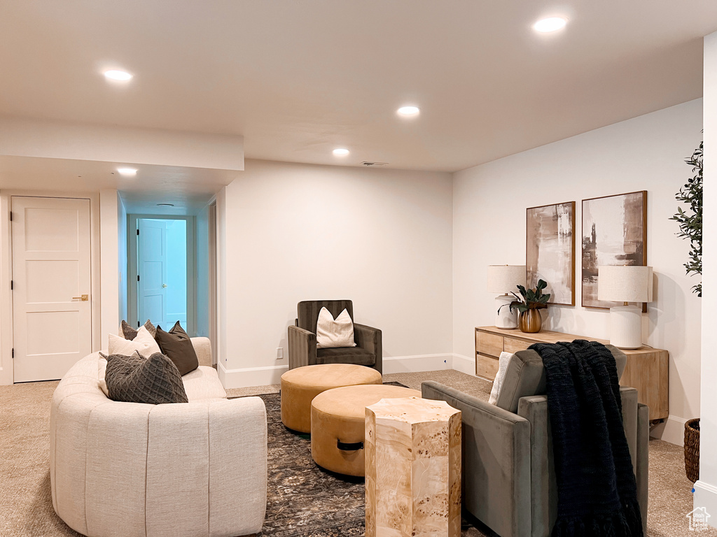 Carpeted living room with recessed lighting and baseboards