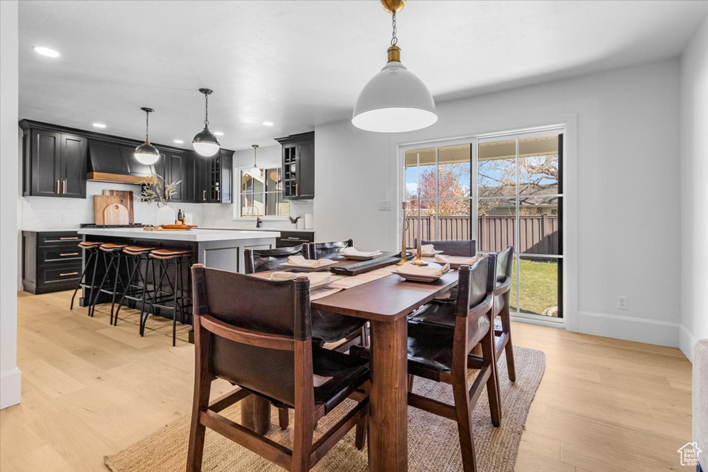 Dining space with a wealth of natural light, recessed lighting, and light wood-style floors