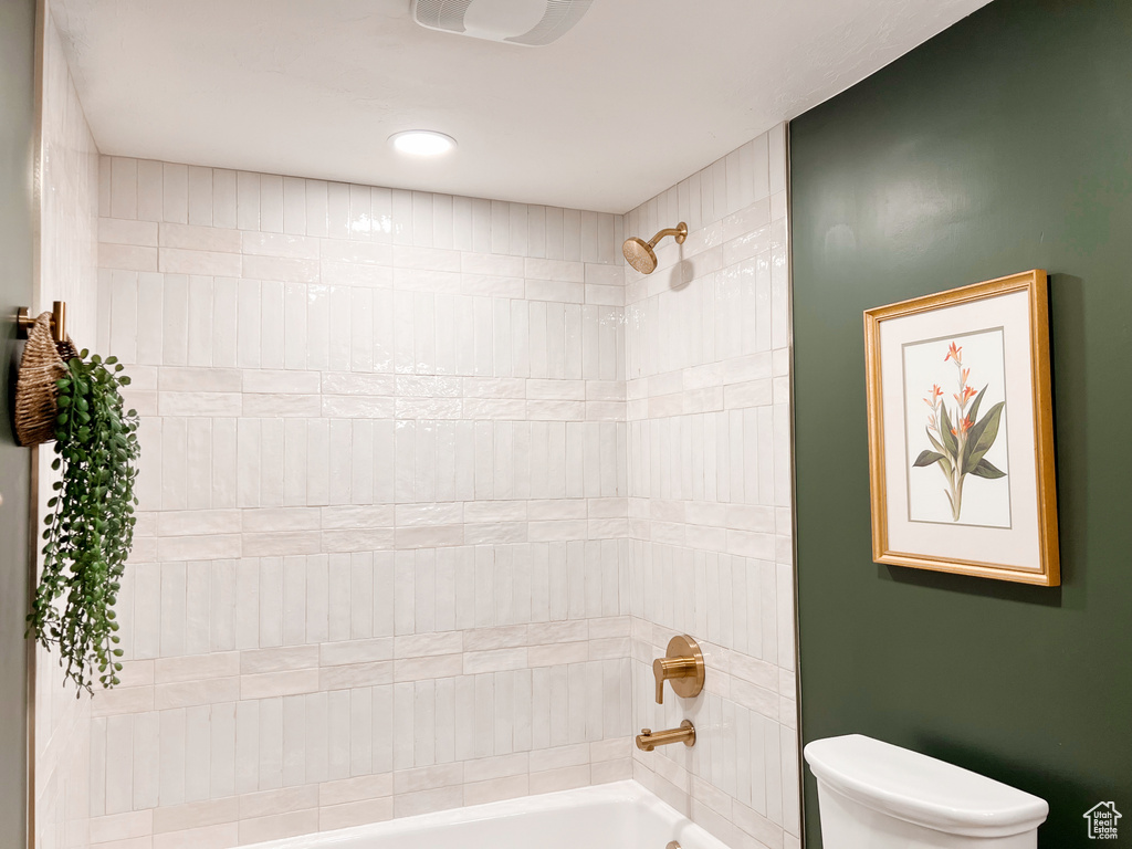 Bathroom featuring toilet and shower / washtub combination