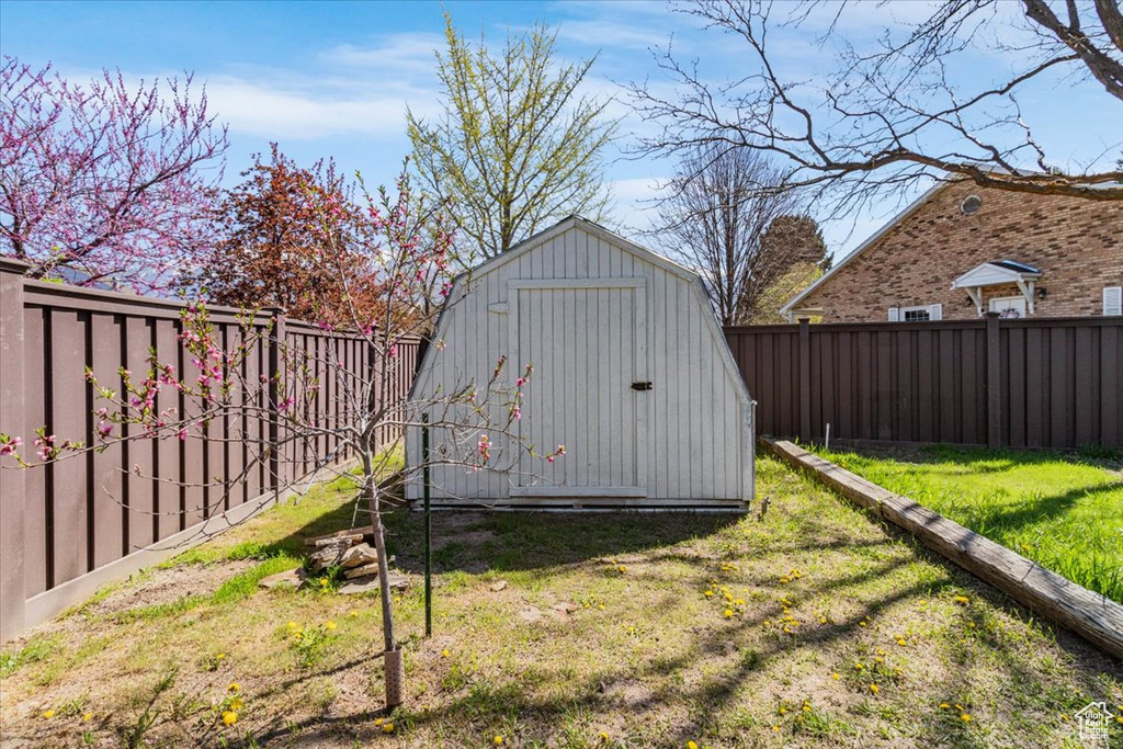 View of shed with a fenced backyard
