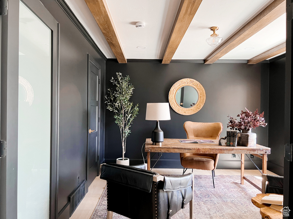 Office area with visible vents, beamed ceiling, and wood finished floors