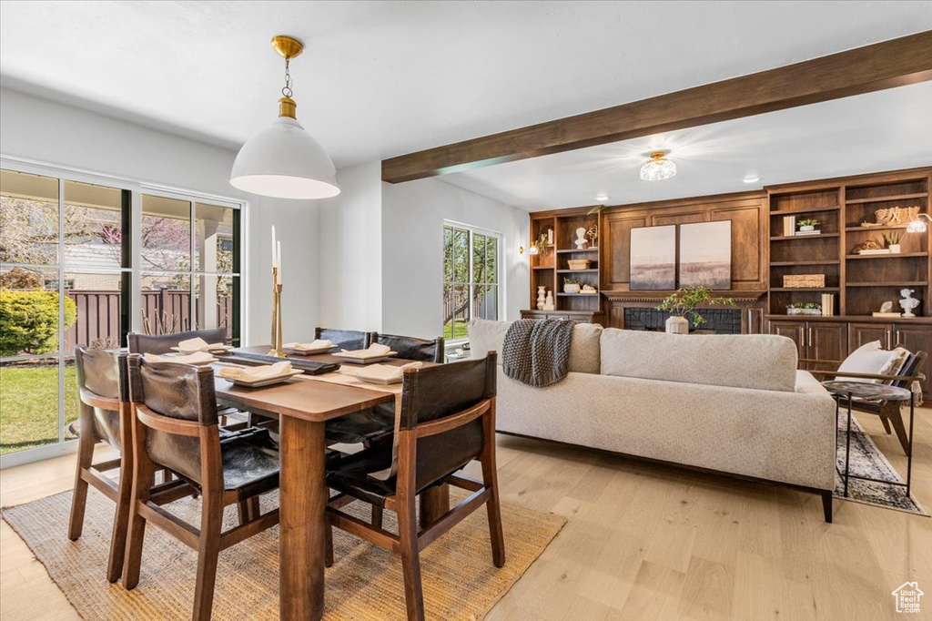 Dining room featuring recessed lighting, light wood-style flooring, and beam ceiling