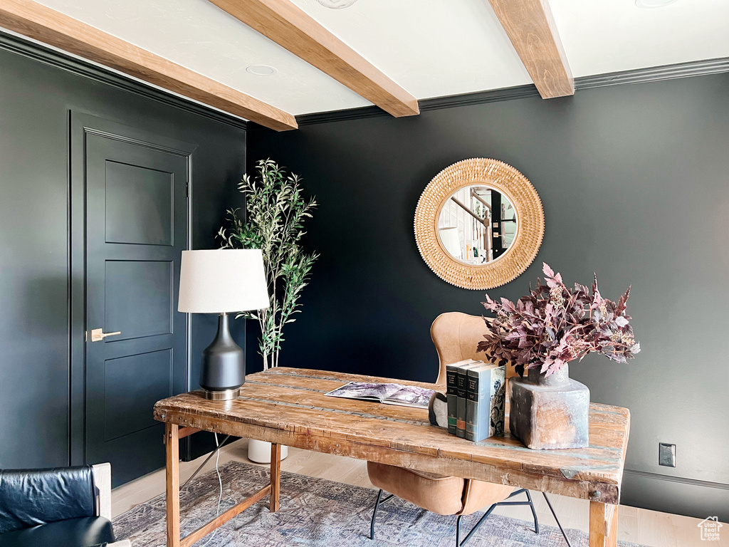 Office space with crown molding, beam ceiling, and wood finished floors