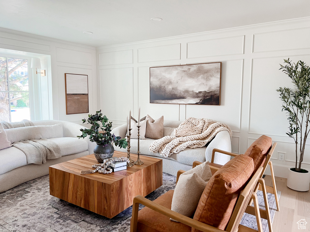 Living room featuring a decorative wall and wood finished floors