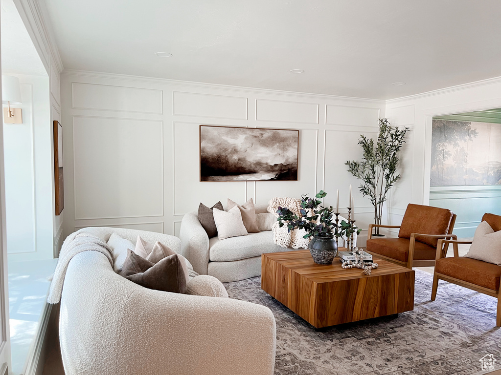 Living room with a decorative wall and ornamental molding