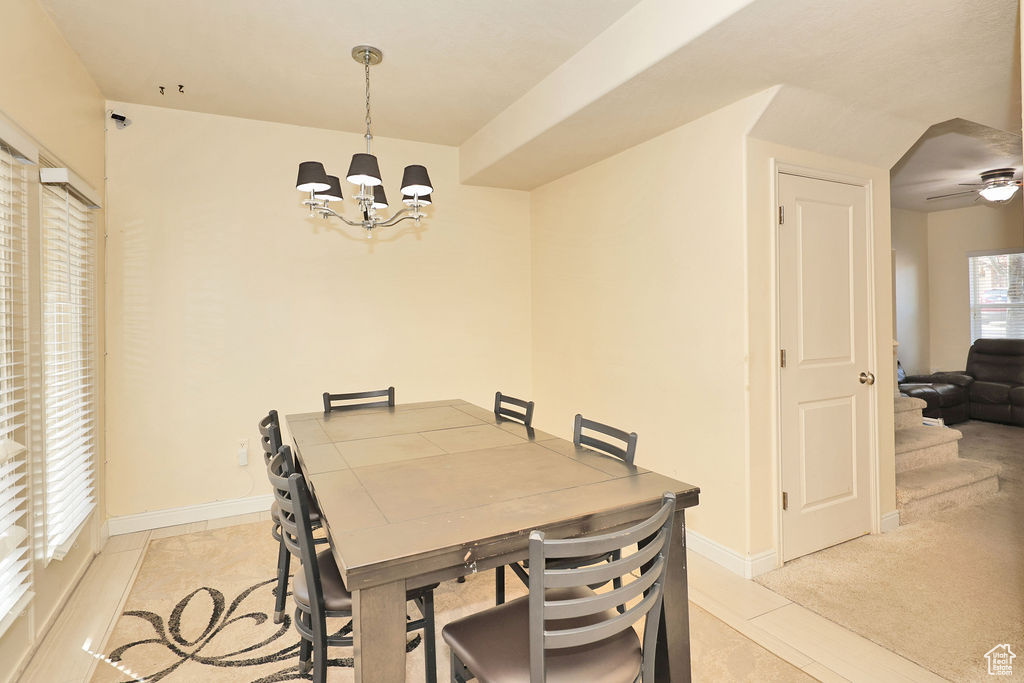 Dining area featuring an inviting chandelier and baseboards