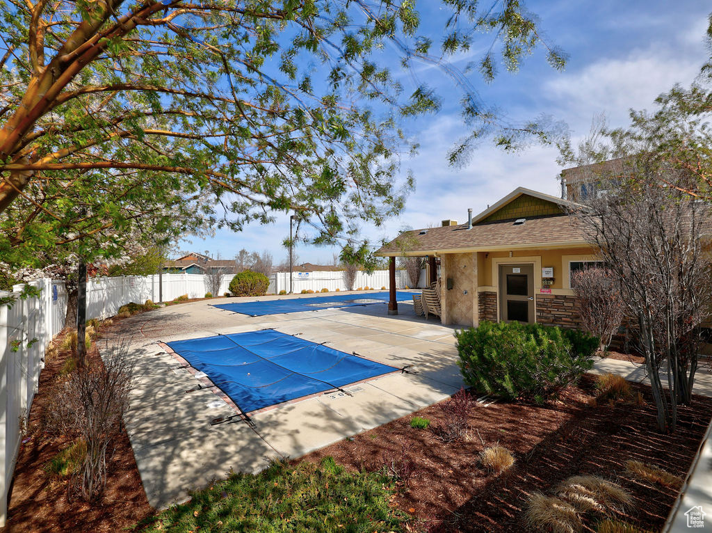 View of pool featuring a fenced backyard, a fenced in pool, and a patio area