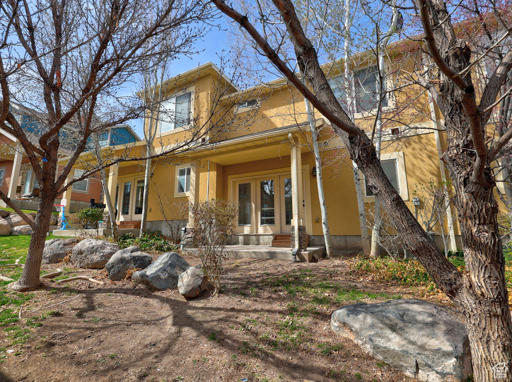 View of front of house with french doors and stucco siding