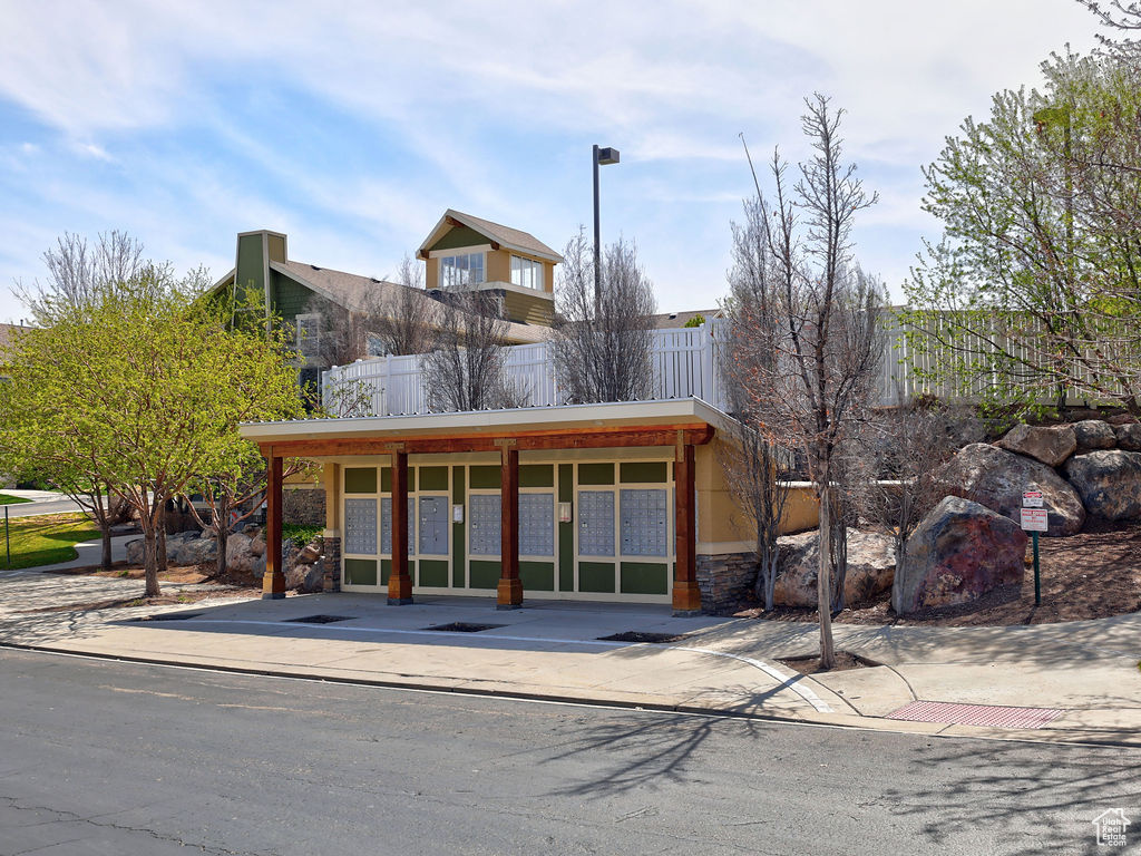 View of front facade with fence and stone siding