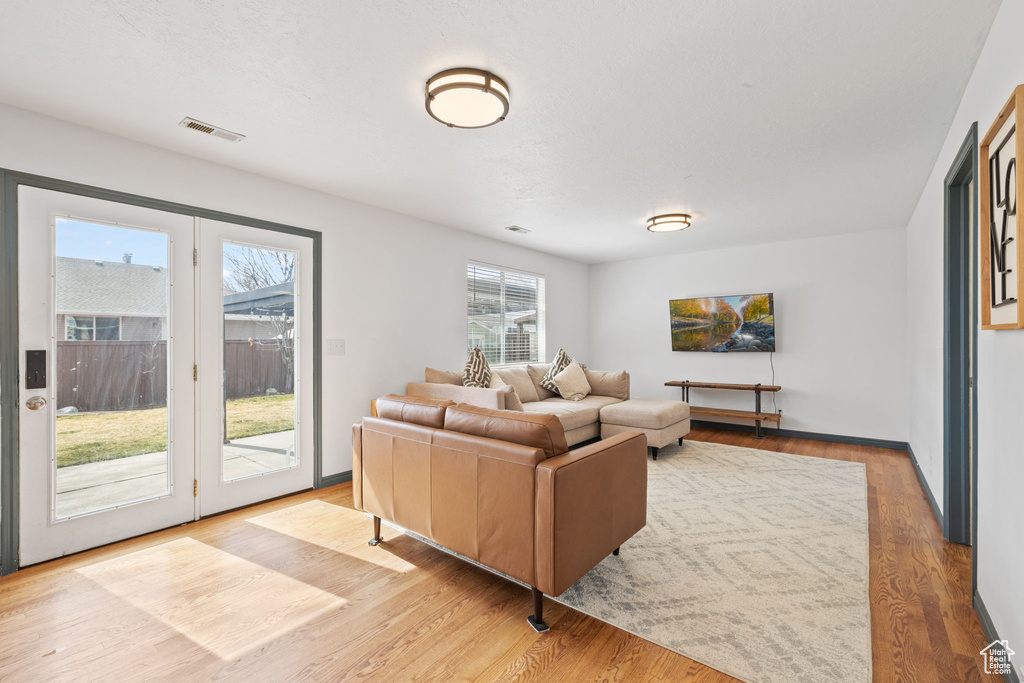 Living area with visible vents and wood finished floors