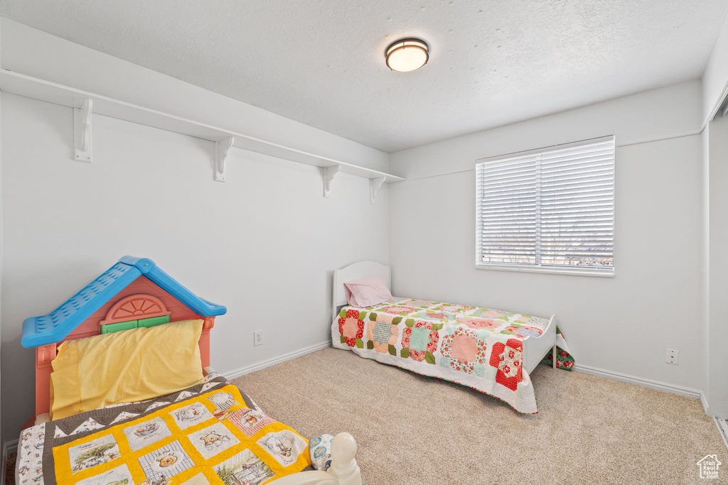 Bedroom with carpet and baseboards