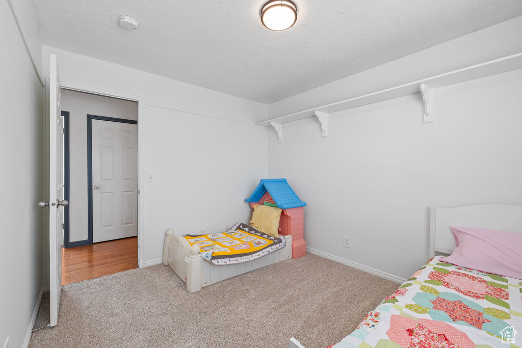 Carpeted bedroom with baseboards