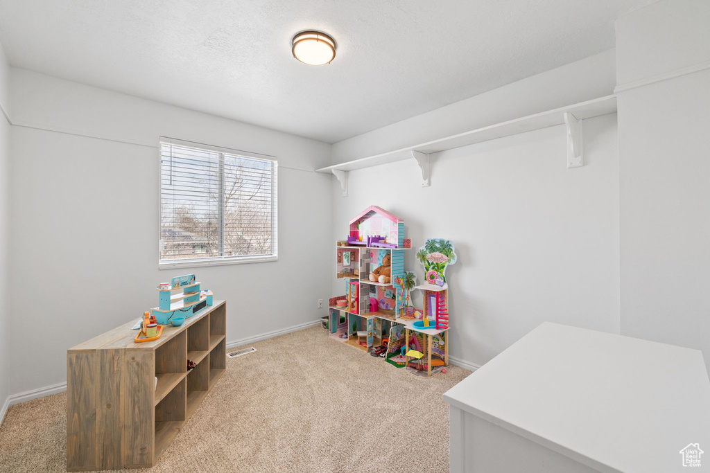 Playroom with carpet flooring and baseboards