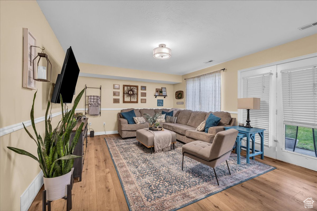 Living area featuring visible vents and light wood-style flooring