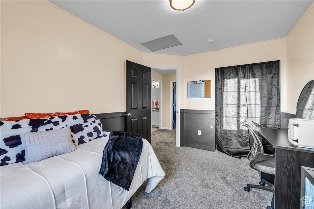 Carpeted bedroom with a wainscoted wall