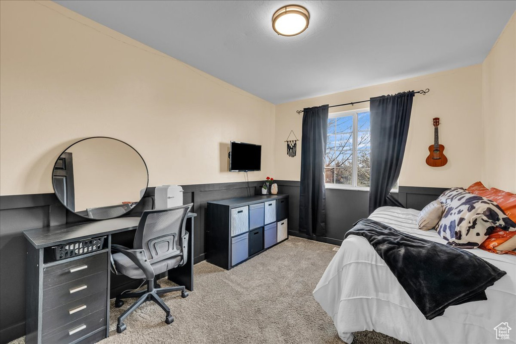 Bedroom with light colored carpet and vaulted ceiling