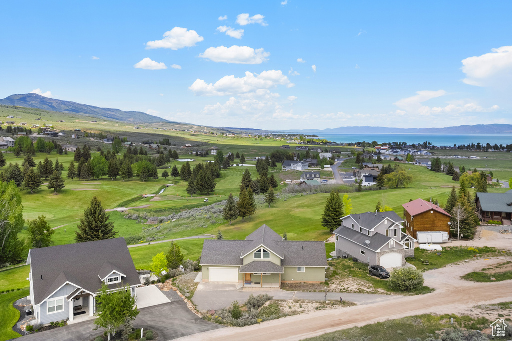 Aerial view of property and surrounding area with a water and mountain view