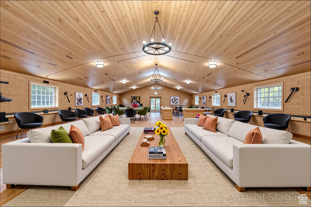 Living room with vaulted ceiling, a chandelier, wooden ceiling, and wood finished floors