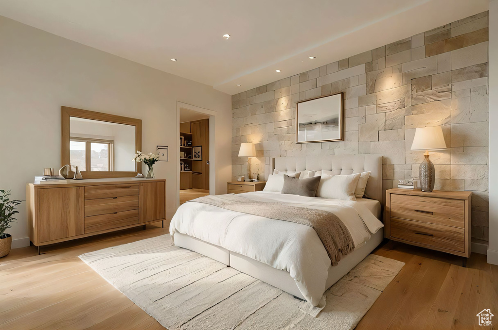 Bedroom featuring recessed lighting, tile walls, an accent wall, and light wood-type flooring