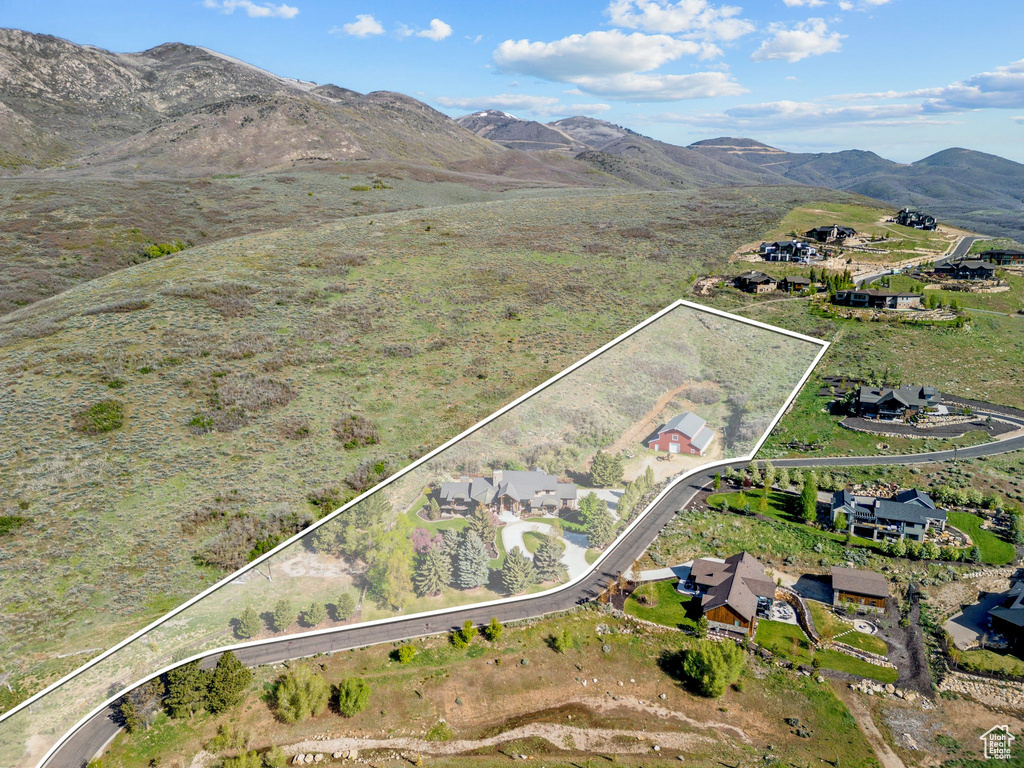 Aerial overview of property\'s location featuring property parcel outlined and a mountain backdrop
