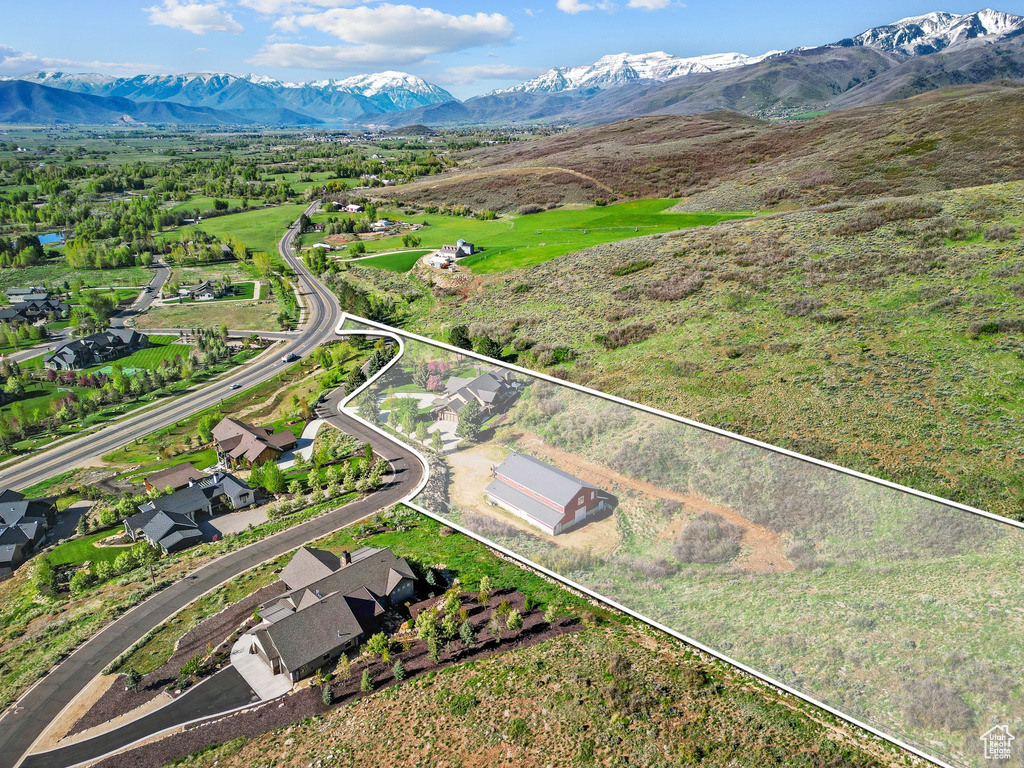 Aerial overview of property\'s location with a mountain backdrop and property parcel outlined