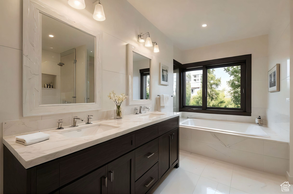 Full bath featuring a garden tub, double vanity, a shower, and tile patterned flooring