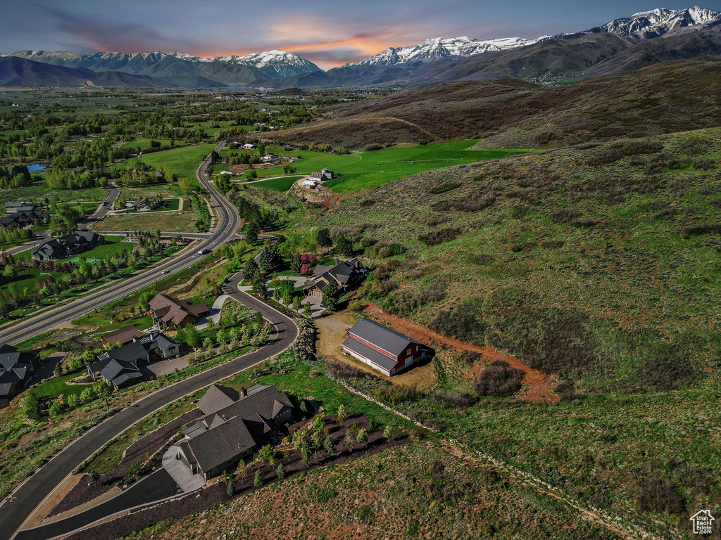 Aerial view of property and surrounding area featuring mountains