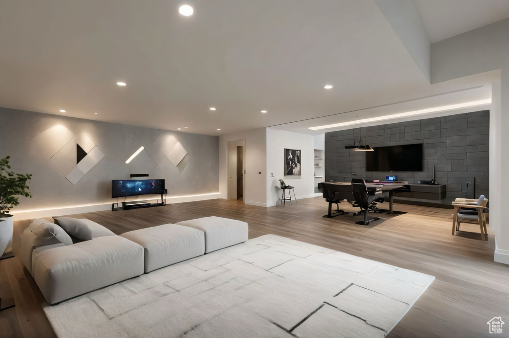 Living room with light wood-type flooring and recessed lighting