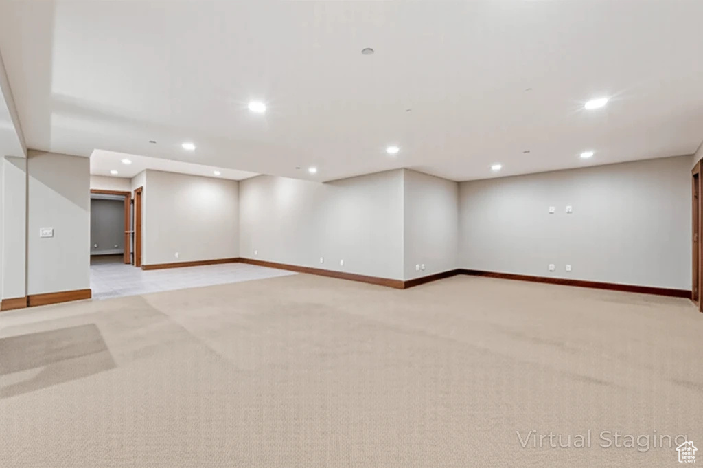 Spare room with recessed lighting and light carpet