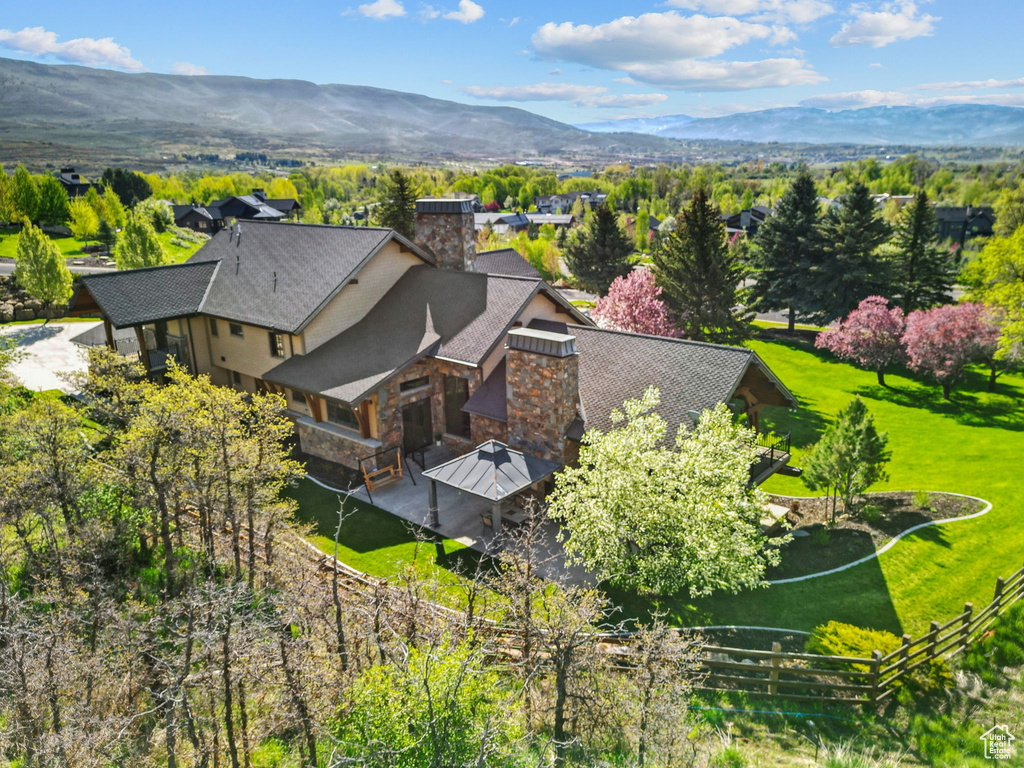 Aerial view of property and surrounding area featuring mountains