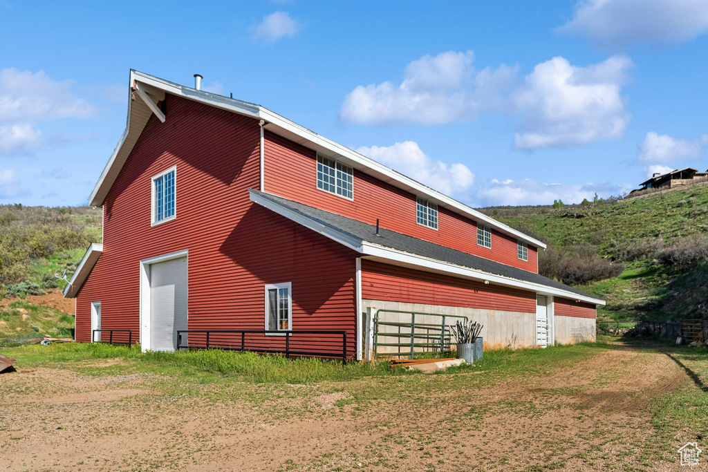 Back of property featuring a garage