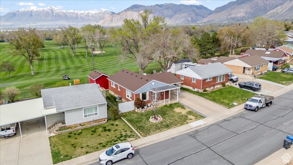 Drone / aerial view featuring view of golf course, a residential view, and a mountain view