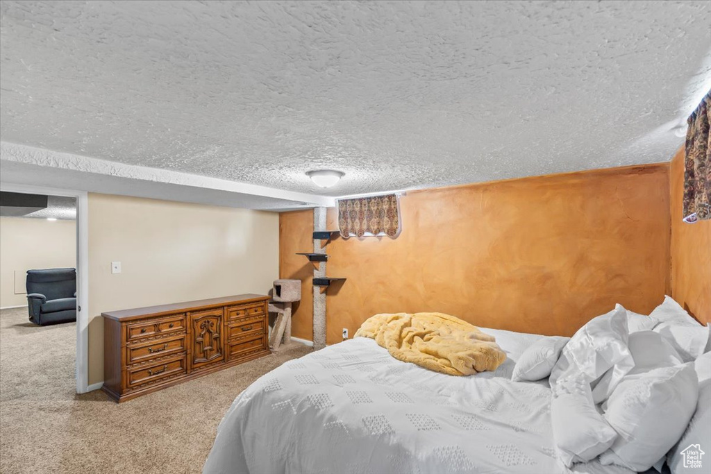 Bedroom featuring a textured ceiling and carpet flooring