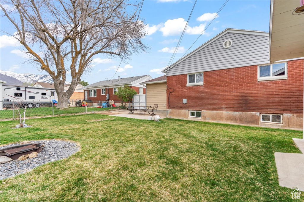 View of yard with a patio, a residential view, and fence