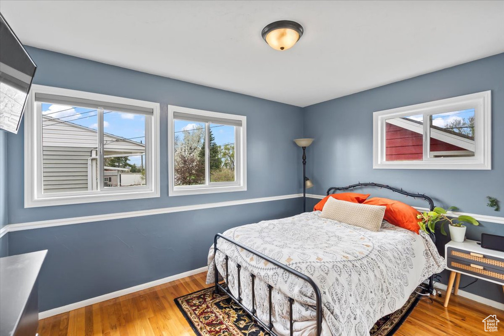 Bedroom with baseboards and wood finished floors