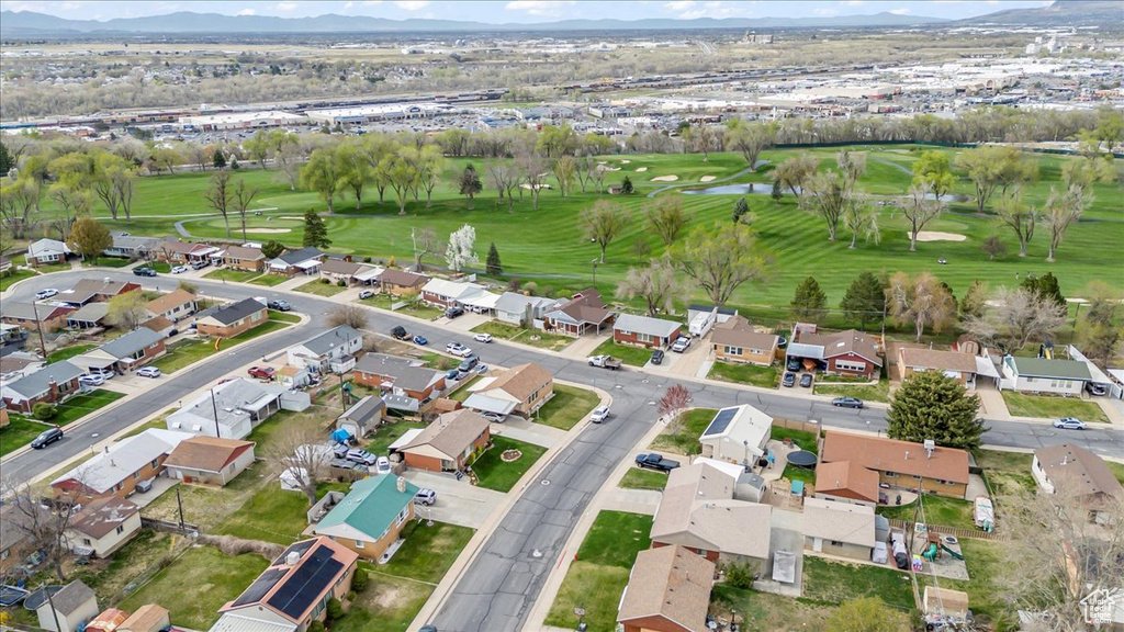 Drone / aerial view featuring golf course view, a water and mountain view, and a residential view