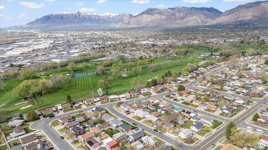 Birds eye view of property featuring golf course view, a water and mountain view, and a residential view
