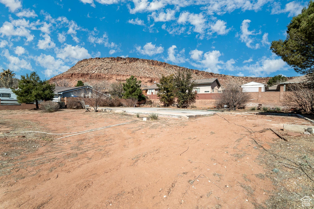 View of yard with a mountain view and fence