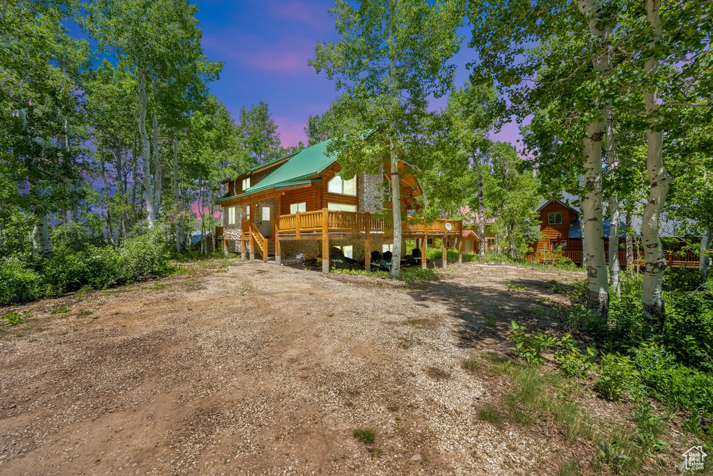 View of front of property featuring a deck and metal roof