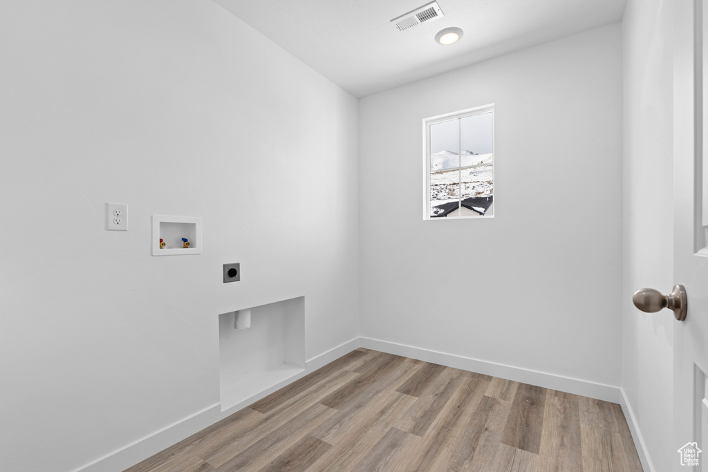 Laundry area featuring laundry area, hookup for a washing machine, visible vents, hookup for an electric dryer, and baseboards