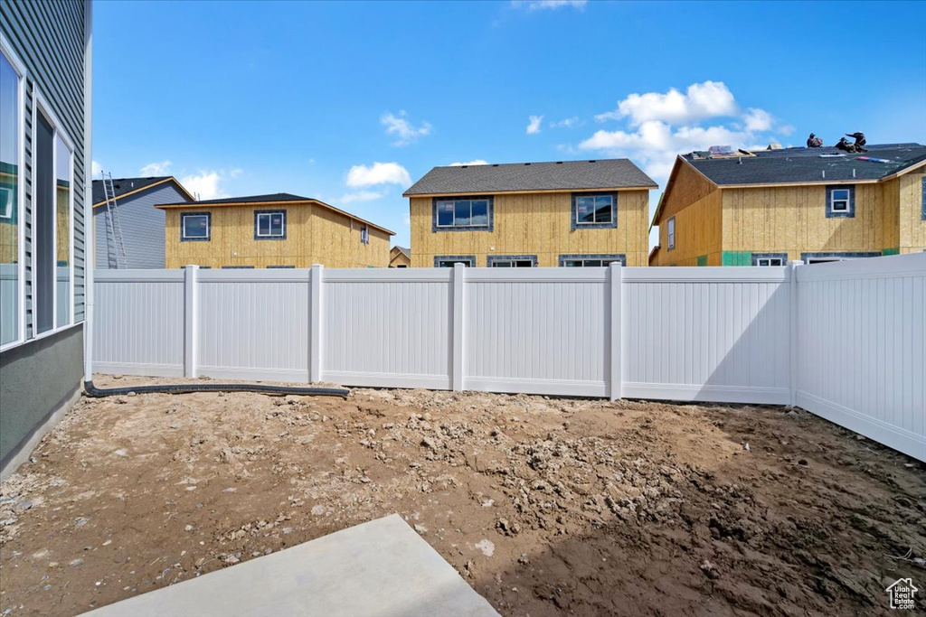 View of yard featuring a fenced backyard and a residential view