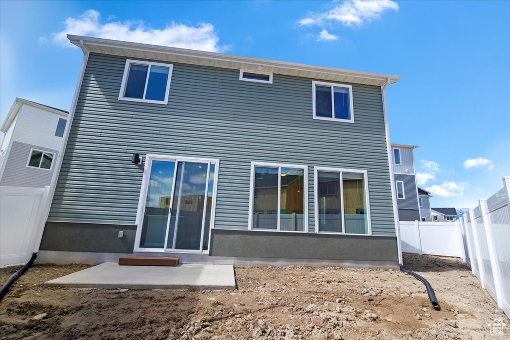 Rear view of house featuring a patio and a fenced backyard