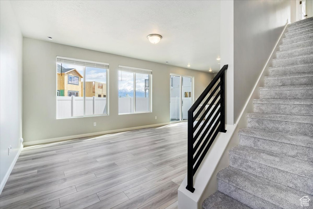 Staircase featuring wood finished floors and baseboards