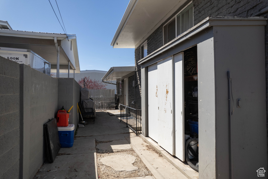 View of side of home featuring fence