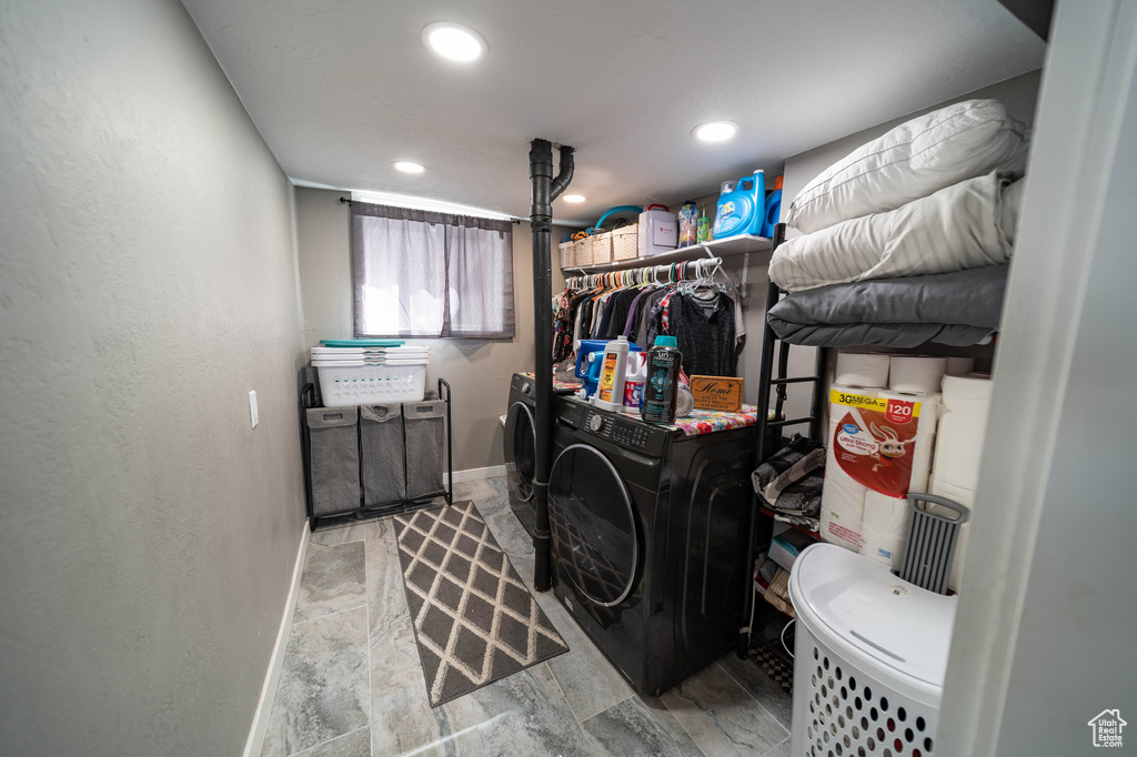 Clothes washing area featuring independent washer and dryer, baseboards, and recessed lighting