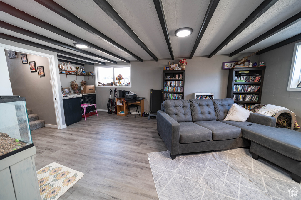 Living area with light wood-style flooring and baseboards