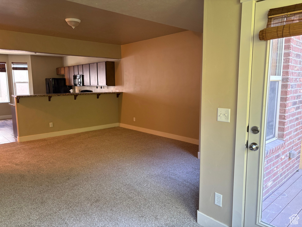 Empty room with carpet and baseboards
