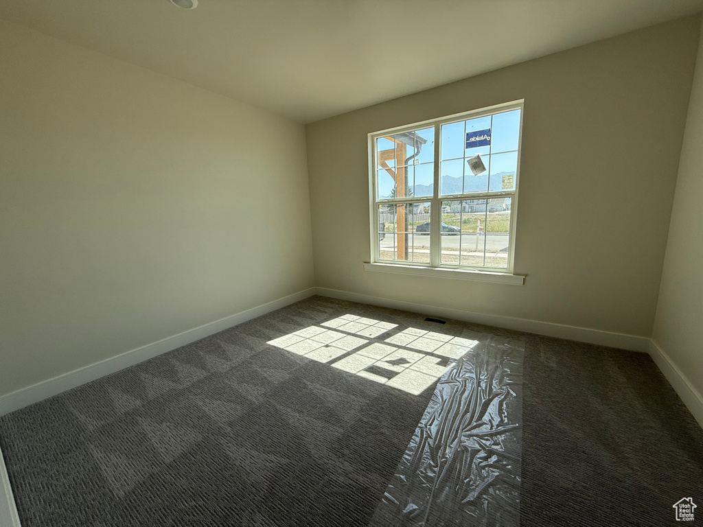 Empty room with carpet and baseboards